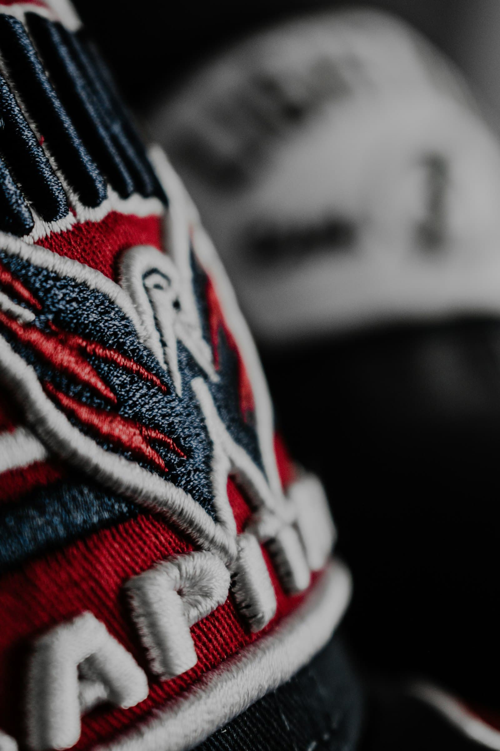 Close-up of an embroidered logo patch on a baseball cap
