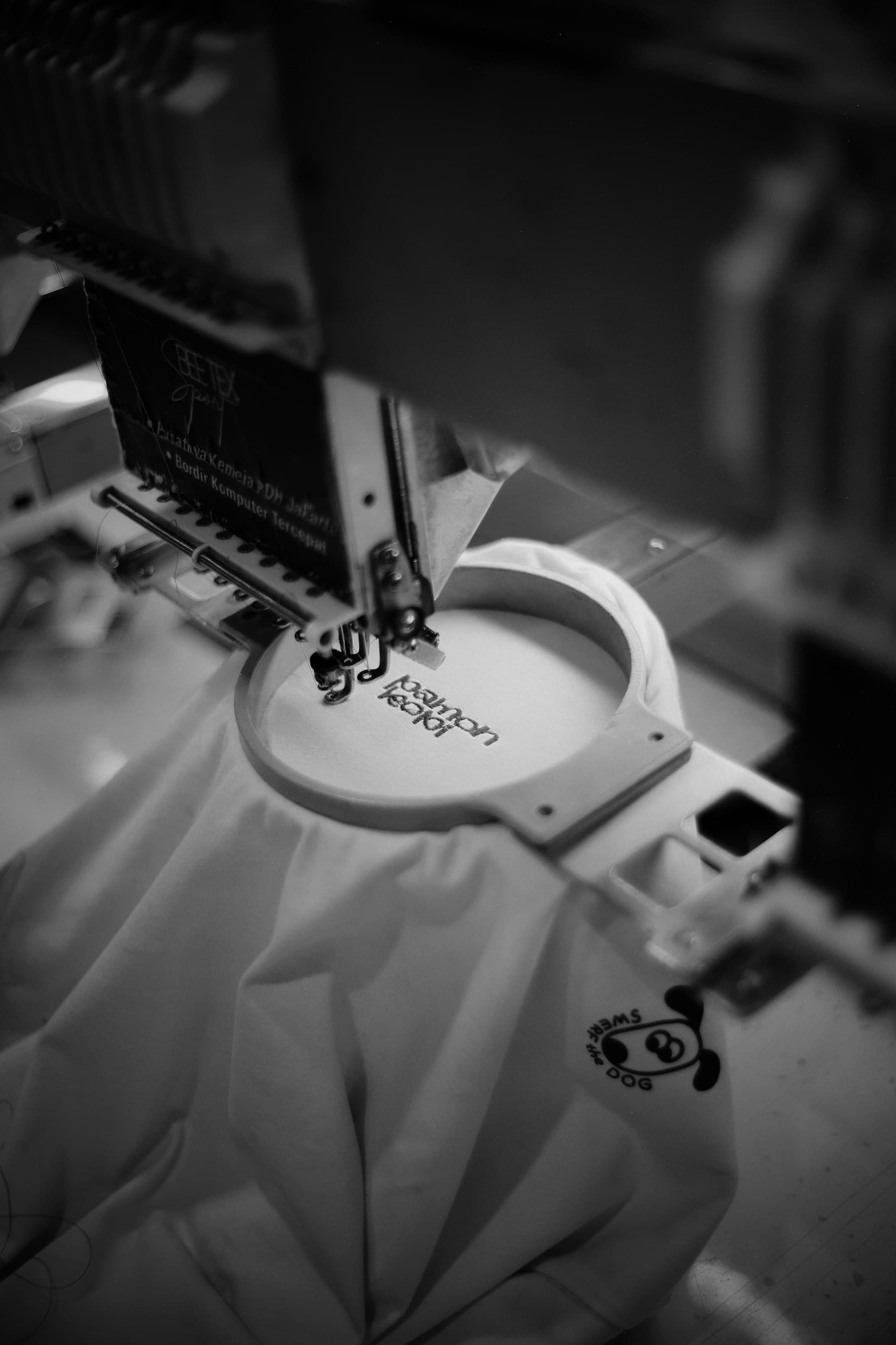 Close-up of an embroidery machine stitching a colorful design onto fabric