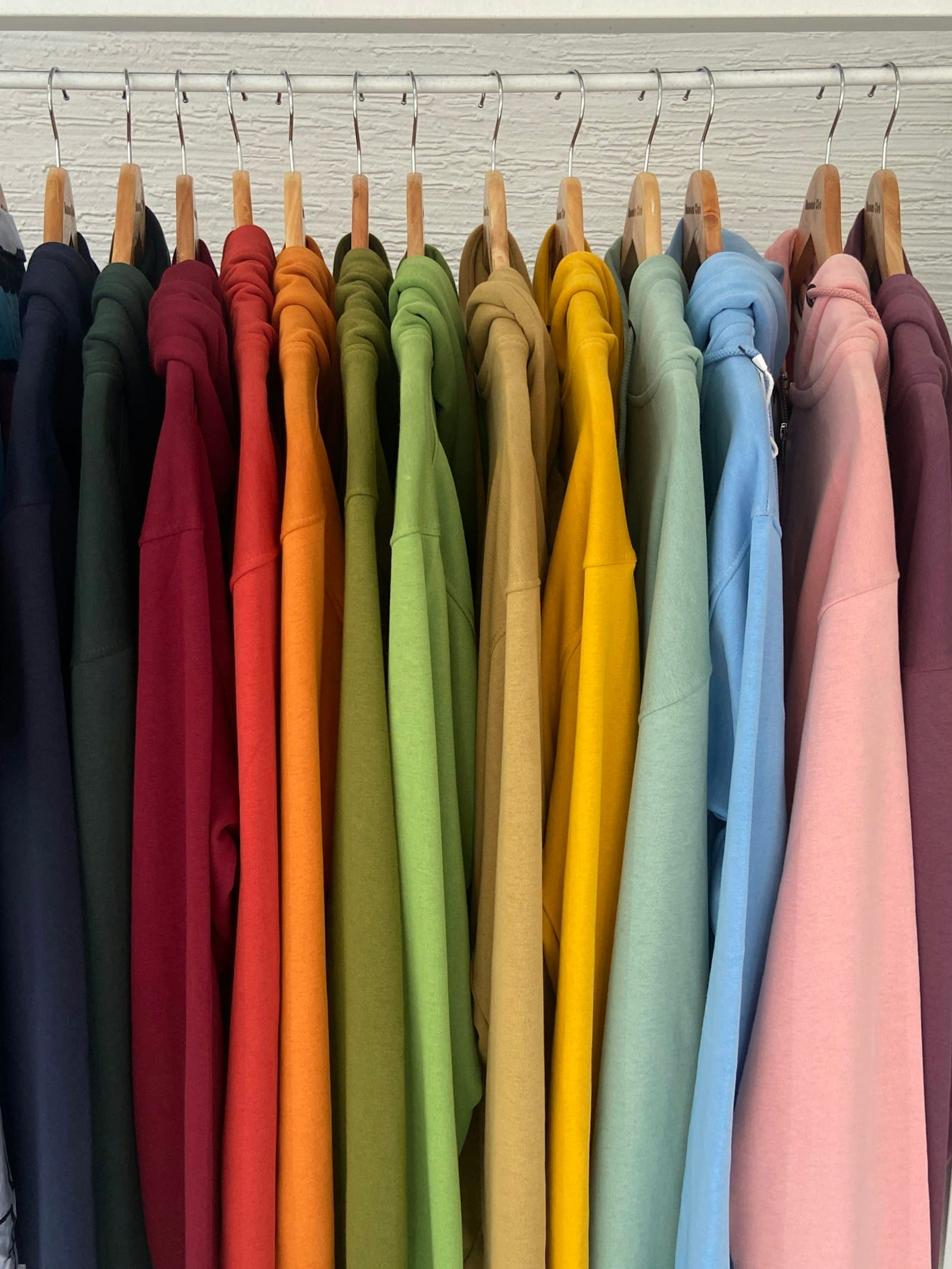 Rack of colorful blank shirts ready for screen printing