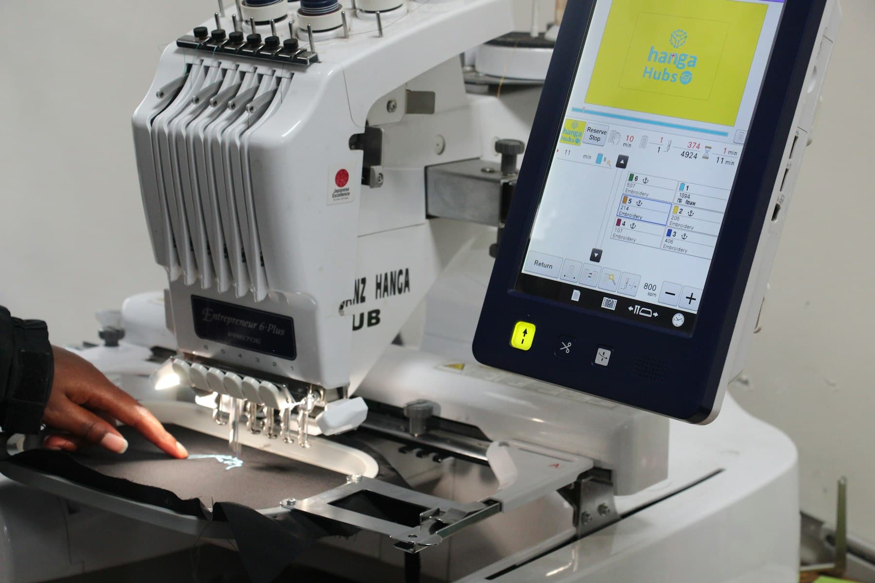 Commercial embroidery machine stitching a design in a Loveland embroidery shop