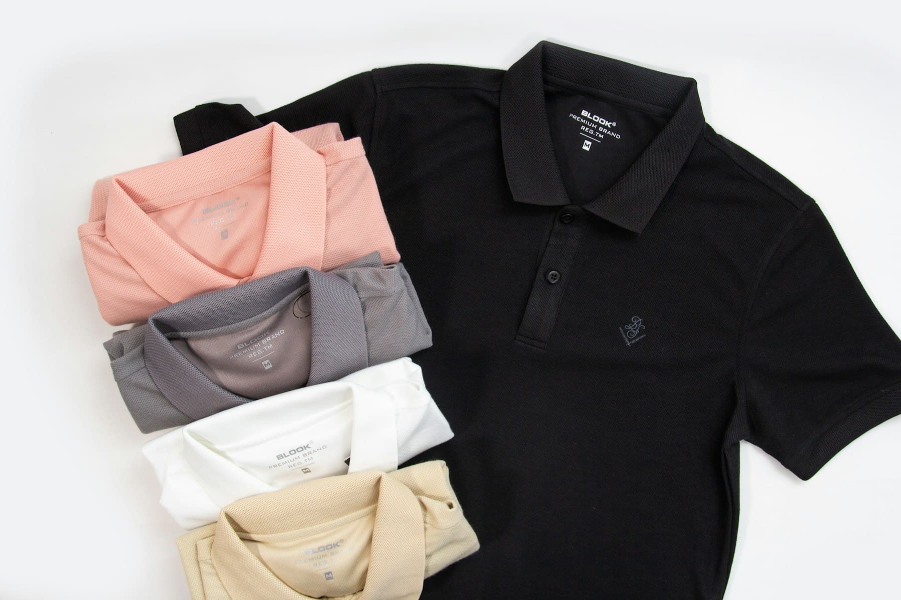 Row of corporate polo shirts in multiple colors ready for embroidery